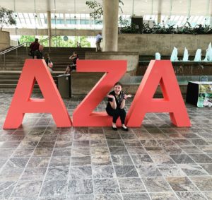 Meg Warburton sitting on large AZA sculpture