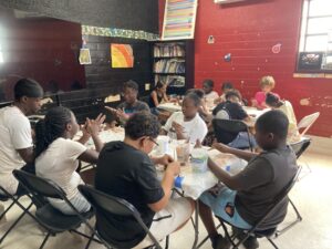 Eli Nixon, students building clay sparrows at The Davey Lopes Community Center